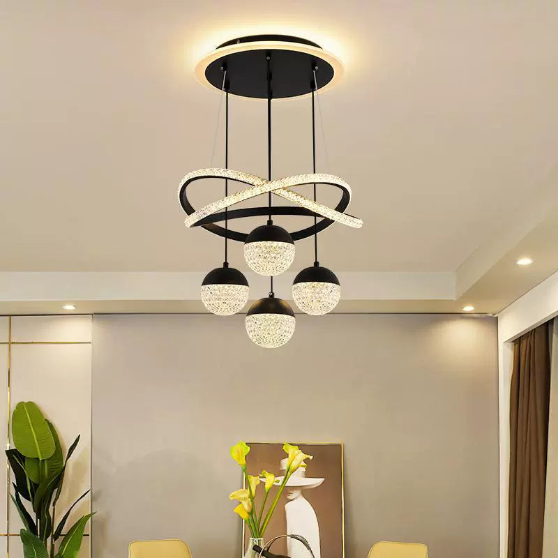 Black LED chandelier with intersecting rings and four acrylic globes in a dining room